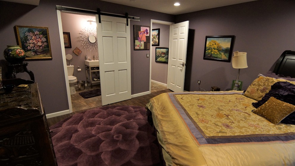 Photo of a mid-sized eclectic look-out basement in Other with purple walls and vinyl floors.