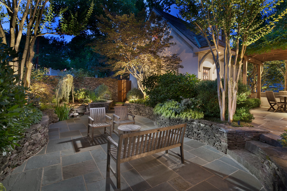 Photo of a traditional patio in DC Metro with a water feature and natural stone pavers.