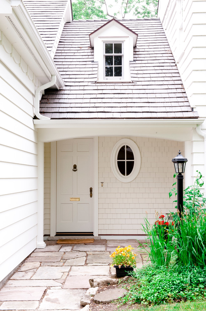 This is an example of a traditional entryway in Toronto with a white front door.