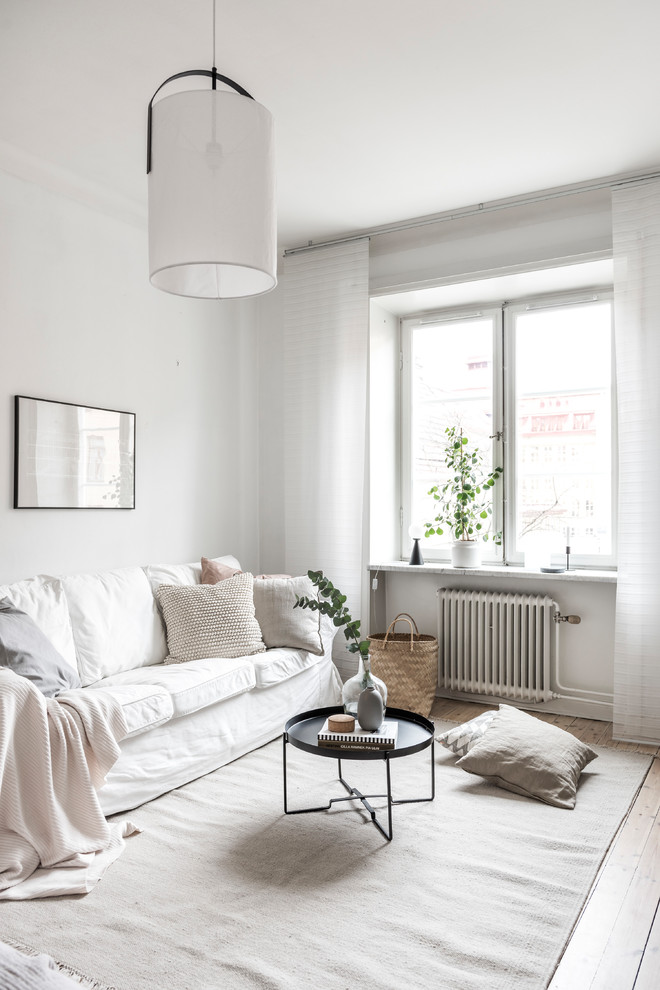 Inspiration for a scandinavian living room in Stockholm with white walls.