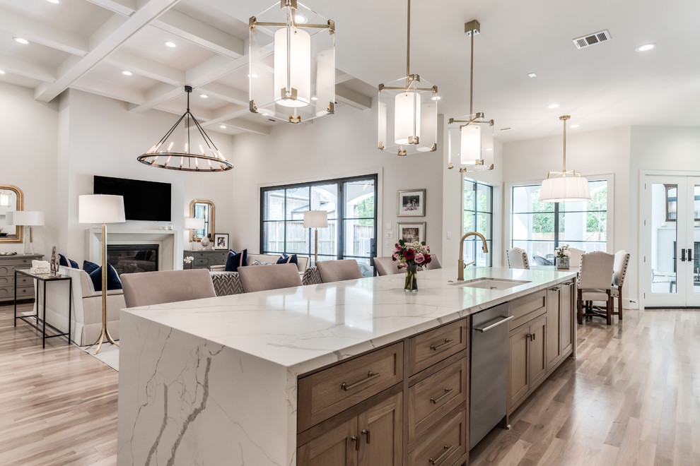 Design ideas for an expansive transitional open plan kitchen in Houston with an undermount sink, shaker cabinets, quartz benchtops, stainless steel appliances, light hardwood floors, with island, beige floor, white benchtop and medium wood cabinets.