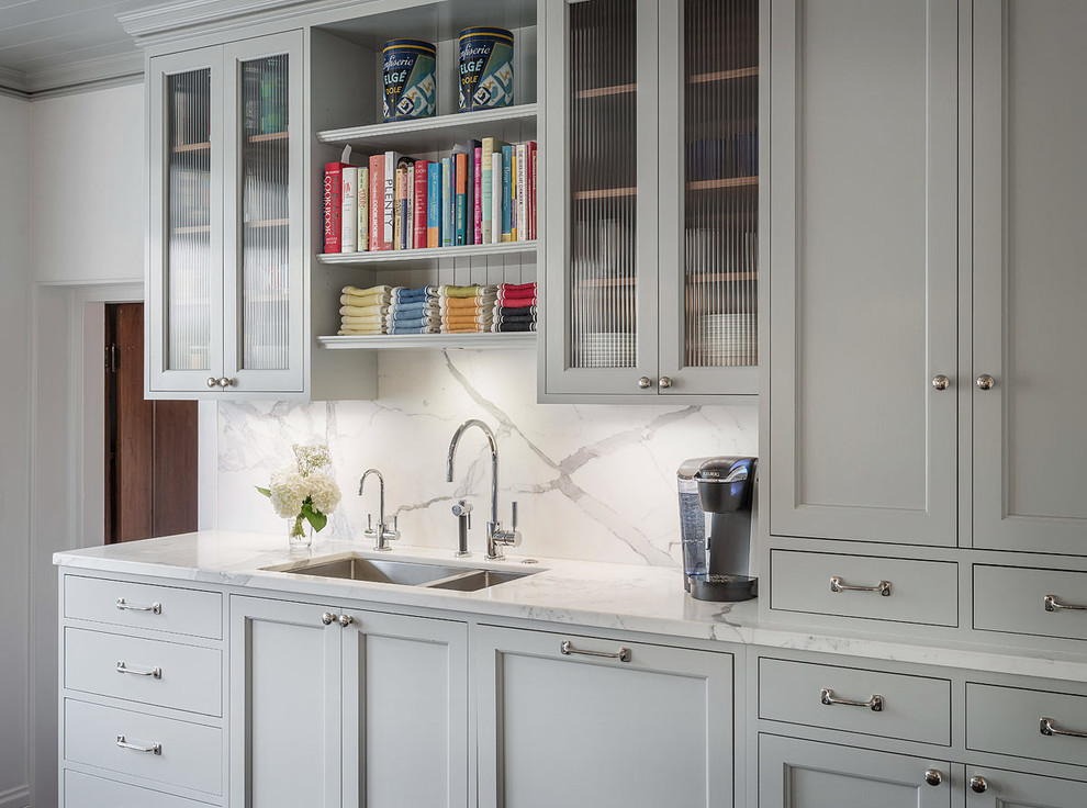 This is an example of a large transitional kitchen in San Francisco with a double-bowl sink, shaker cabinets, white cabinets, marble benchtops, white splashback and stone slab splashback.