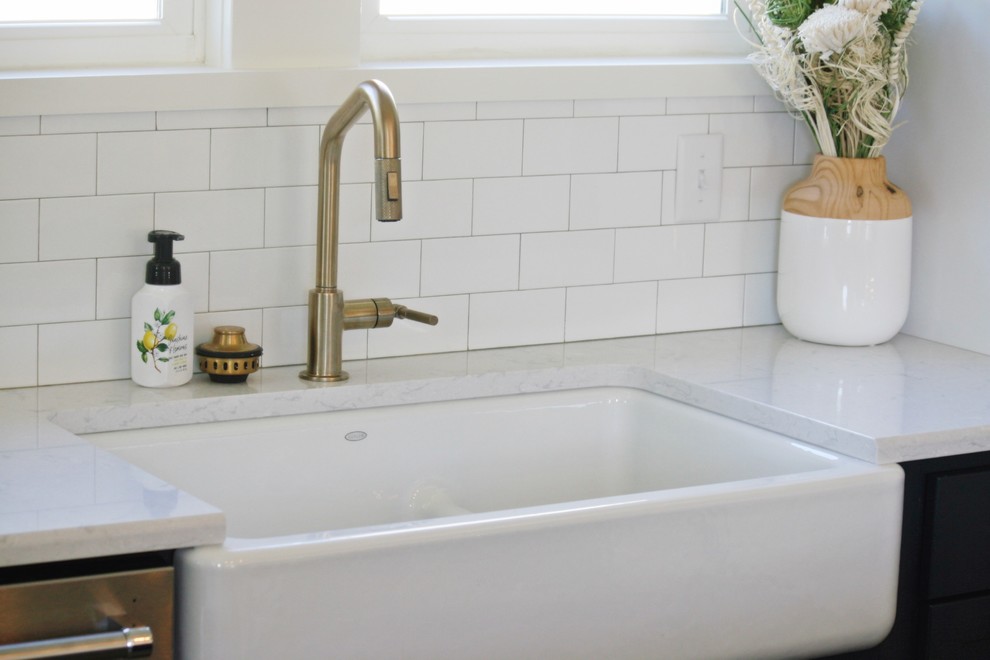 Inspiration for a transitional gray floor kitchen remodel with a farmhouse sink, quartz countertops and stainless steel appliances