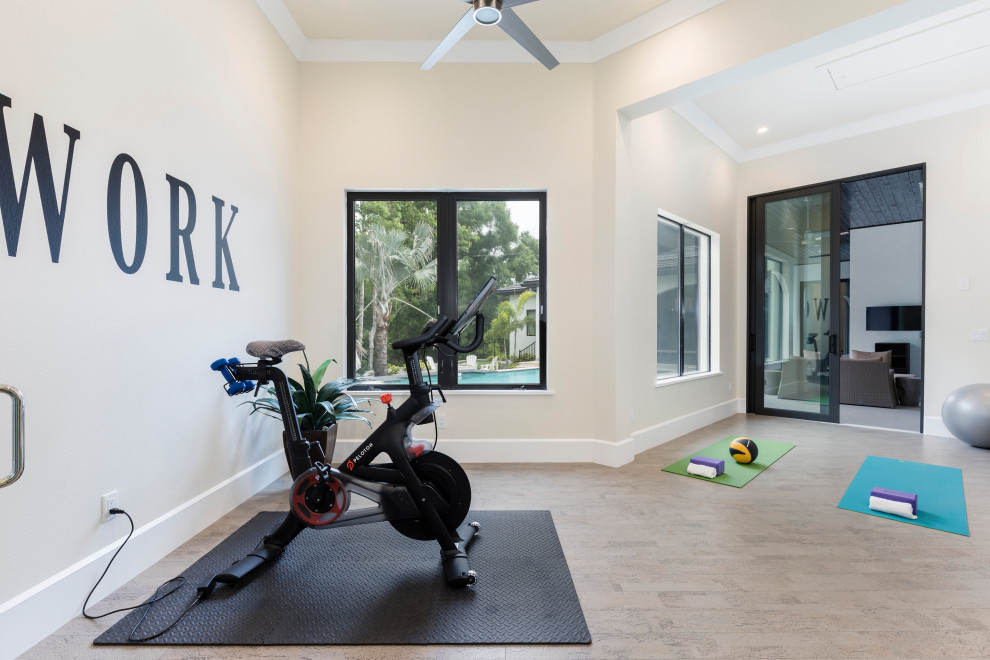 This is an example of a mid-sized modern multipurpose gym in Orlando with beige walls, cork floors and beige floor.