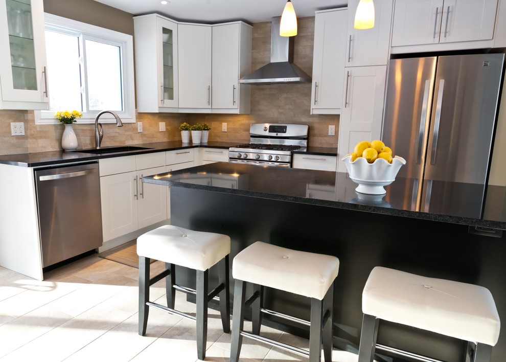 Inspiration for a contemporary l-shaped eat-in kitchen in Ottawa with an undermount sink, shaker cabinets, white cabinets, quartz benchtops, beige splashback, porcelain splashback and stainless steel appliances.