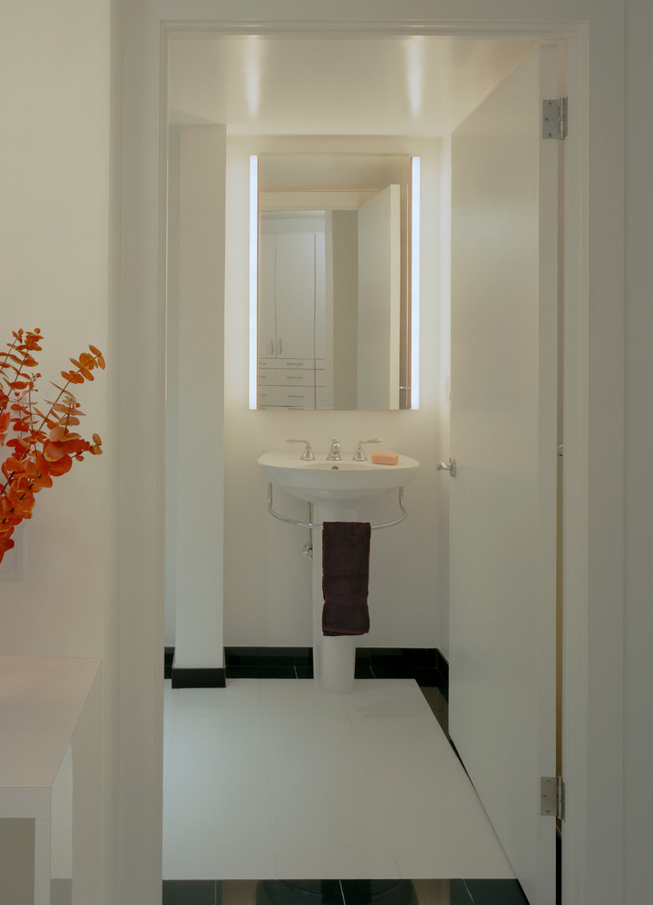 Design ideas for a mid-sized contemporary 3/4 bathroom in New York with a pedestal sink, white tile, porcelain tile, white walls, marble floors, an alcove tub and white floor.