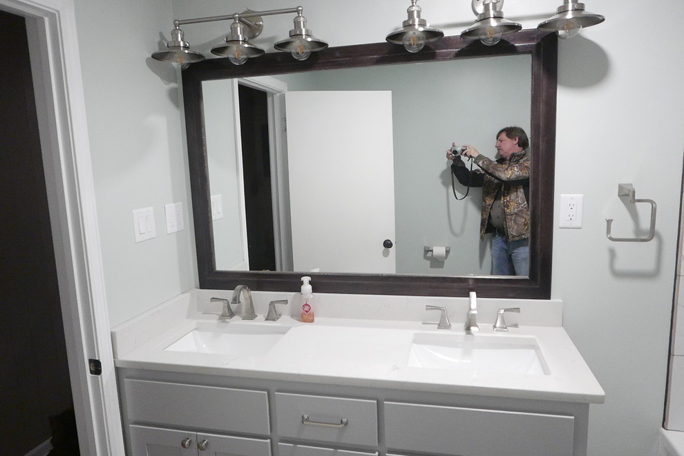 Alcove bathtub - mid-sized transitional kids' white tile and porcelain tile porcelain tile and gray floor alcove bathtub idea with shaker cabinets, gray cabinets, a two-piece toilet, green walls, an undermount sink, quartz countertops and white countertops