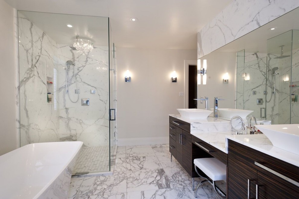 Photo of a large contemporary master bathroom in Toronto with flat-panel cabinets, dark wood cabinets, a freestanding tub, a corner shower, white tile, stone slab, grey walls, marble floors, a vessel sink and marble benchtops.