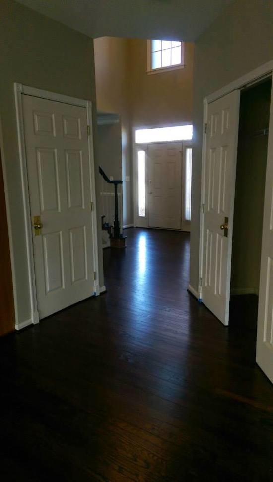 Mid-sized transitional dark wood floor hallway photo in Baltimore with beige walls