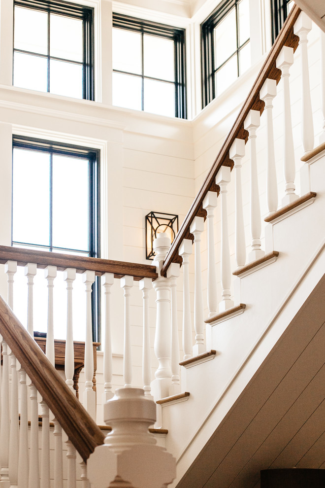This is an example of a traditional wood u-shaped staircase in Charleston with wood risers.