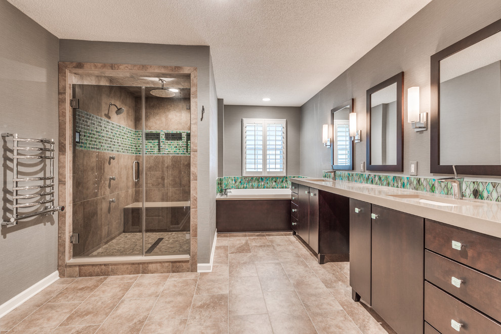 This is an example of a large transitional master bathroom in Jacksonville with shaker cabinets, dark wood cabinets, a drop-in tub, a double shower, green tile, glass tile, green walls, porcelain floors, an undermount sink and engineered quartz benchtops.