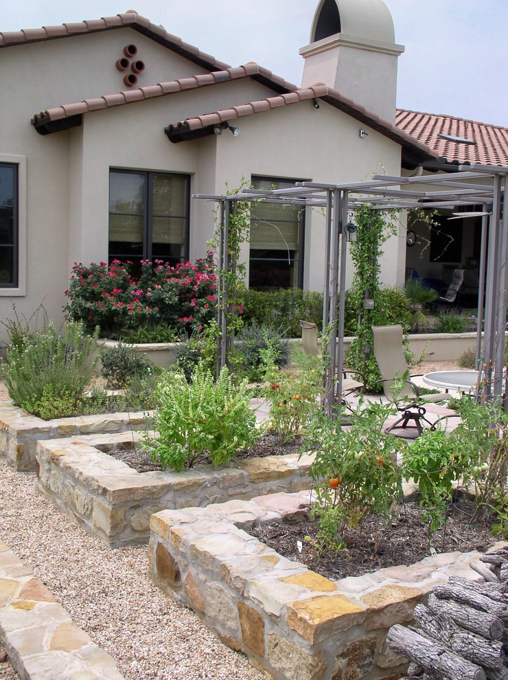 Inspiration for a mediterranean garden in Austin with a vegetable garden.