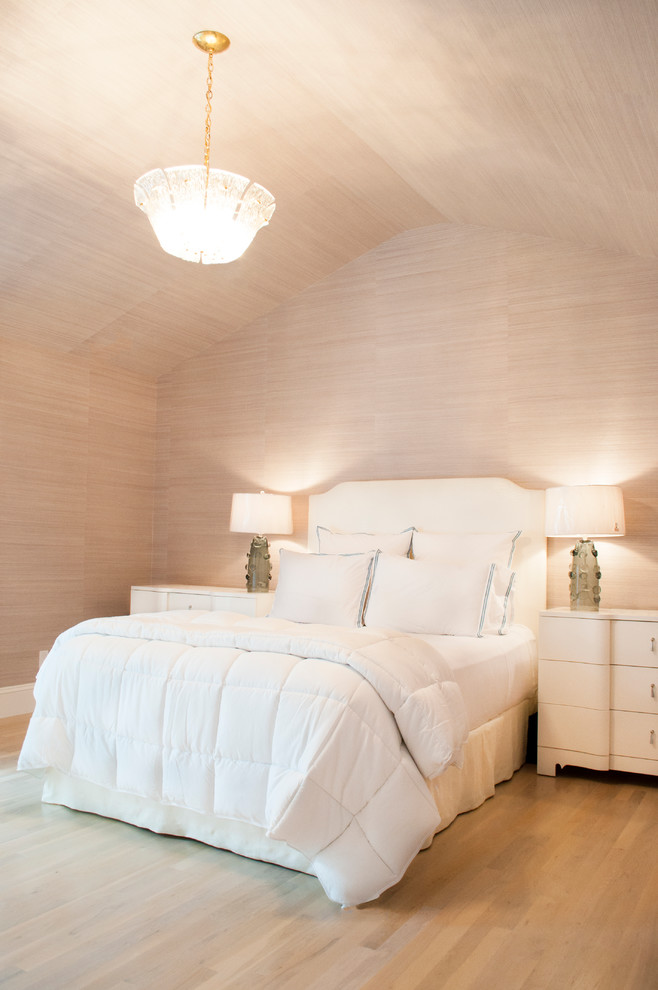 Photo of a beach style bedroom in New York with beige walls and light hardwood floors.