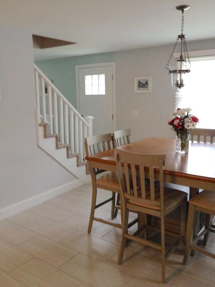 Photo of a mid-sized traditional kitchen/dining combo in Boston with white walls, ceramic floors and no fireplace.