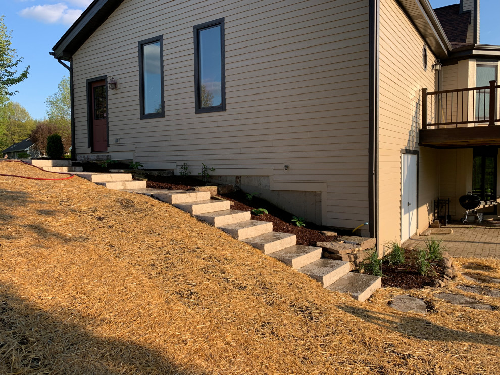 Photo of a mid-sized traditional partial sun hillside stone walkway in Chicago for summer.