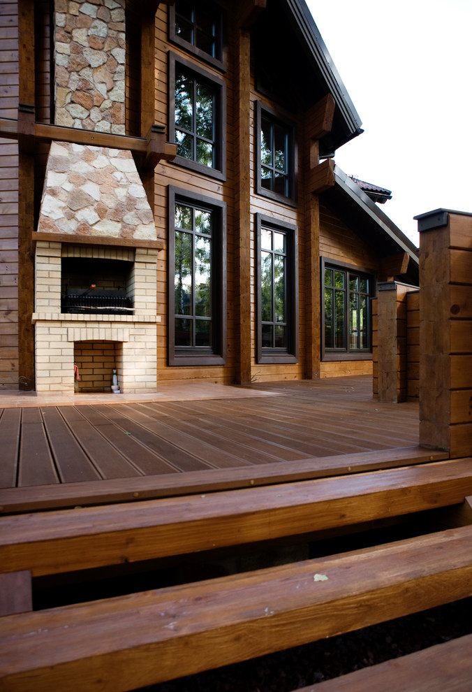 Inspiration for a large deck in Moscow with with fireplace and no cover.