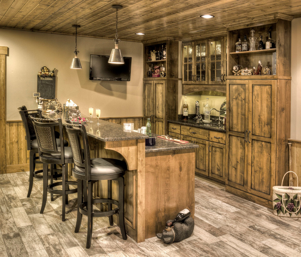 Design ideas for a country galley seated home bar in Minneapolis with an undermount sink, shaker cabinets and dark wood cabinets.