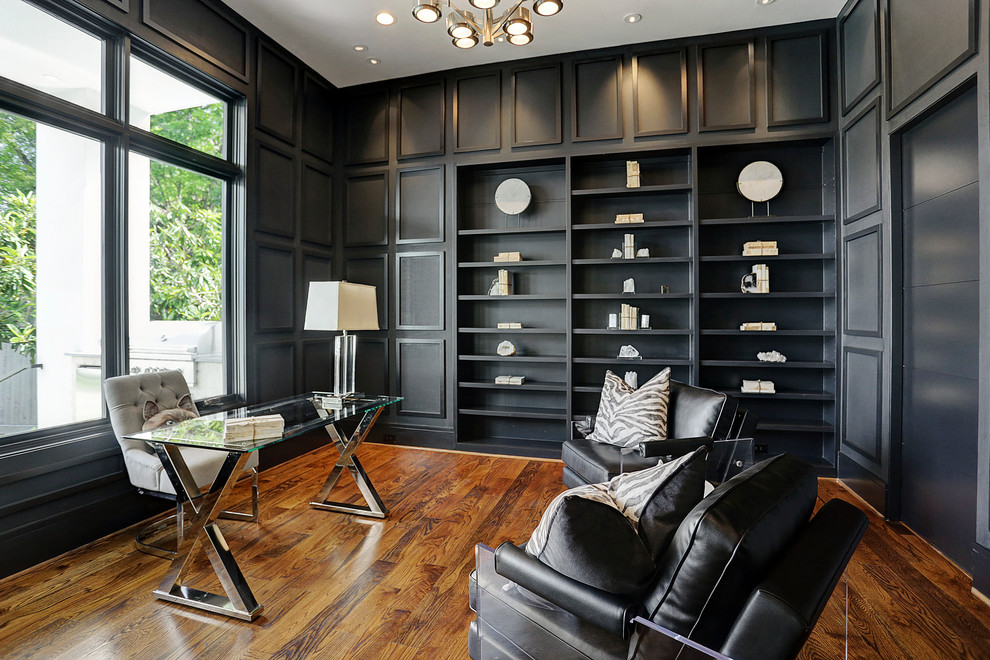 Inspiration for a large transitional study room in Houston with black walls, dark hardwood floors, a freestanding desk and brown floor.