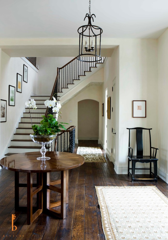 This is an example of an expansive transitional foyer in Atlanta with white walls, dark hardwood floors, a double front door and a medium wood front door.