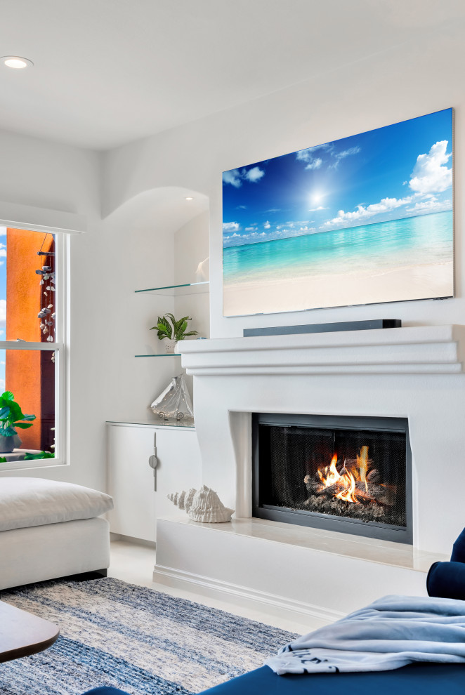 This is an example of a medium sized modern formal open plan living room in Orange County with white walls, carpet, a standard fireplace, a plastered fireplace surround, a wall mounted tv and blue floors.