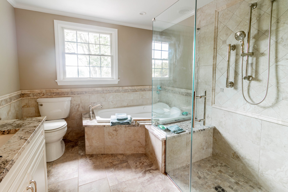 Photo of a mid-sized traditional master bathroom in Other with raised-panel cabinets, white cabinets, a corner tub, a corner shower, a two-piece toilet, beige tile, porcelain tile, beige walls, porcelain floors, an undermount sink, granite benchtops, beige floor, a hinged shower door, beige benchtops, a shower seat, a double vanity, a built-in vanity and decorative wall panelling.