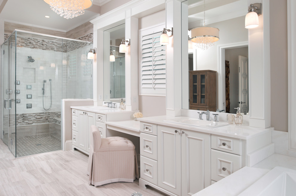 This is an example of an expansive beach style master bathroom in Miami with flat-panel cabinets, white cabinets, gray tile, stone tile, beige walls, a vessel sink, granite benchtops and travertine floors.
