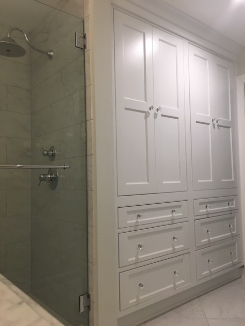 Mid-sized elegant master white tile and porcelain tile porcelain tile and white floor bathroom photo in Charlotte with beaded inset cabinets, white cabinets, a two-piece toilet, white walls, an undermount sink, marble countertops, a hinged shower door and white countertops