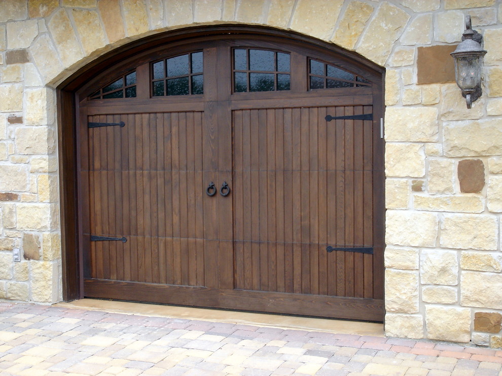 This is an example of a large traditional attached one-car garage in Austin.
