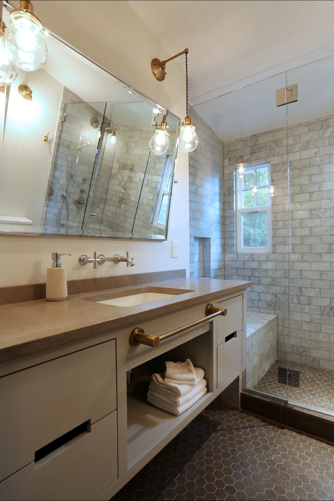 Mid-sized eclectic bathroom in Portland with an undermount sink, furniture-like cabinets, grey cabinets, limestone benchtops, gray tile, stone tile, white walls, limestone floors, a curbless shower and a two-piece toilet.