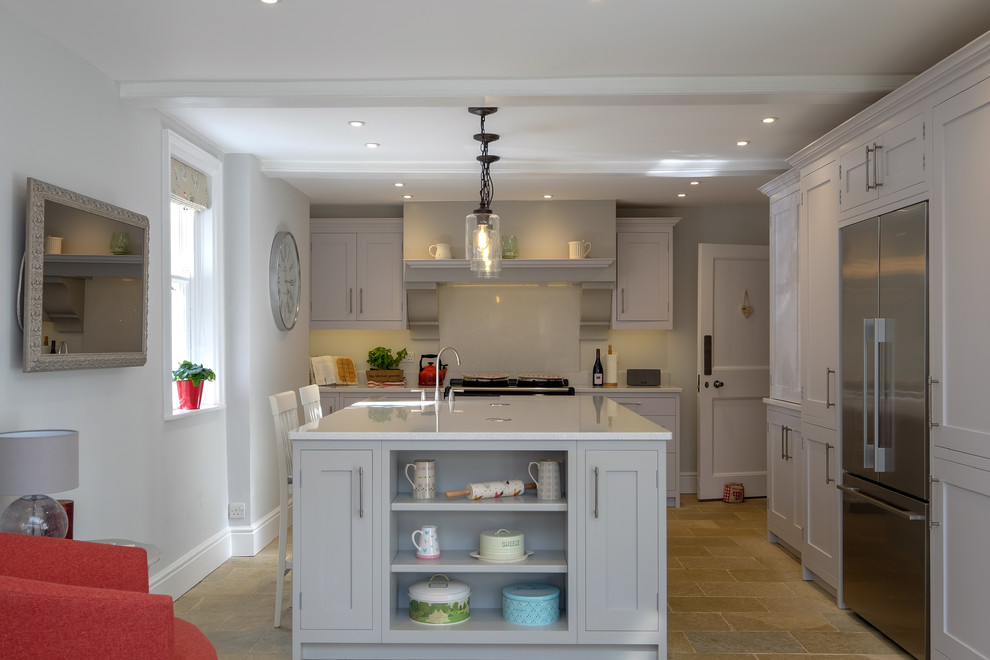Design ideas for a large contemporary galley separate kitchen in Hampshire with a farmhouse sink, shaker cabinets, grey cabinets, quartzite benchtops, white splashback, stainless steel appliances, limestone floors, with island, multi-coloured floor and white benchtop.