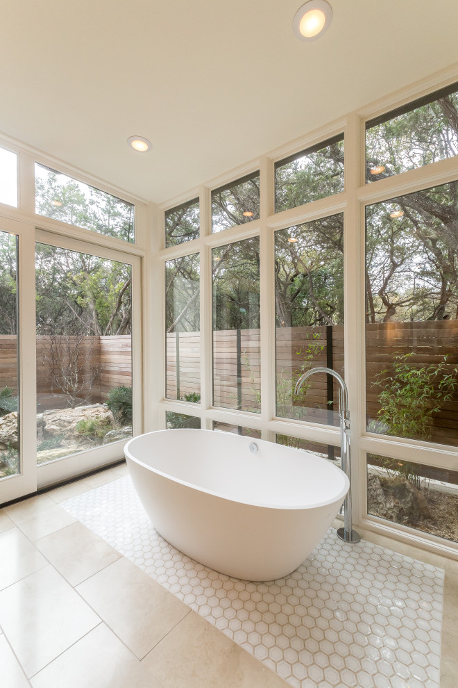 Inspiration for a transitional bathroom in Austin with a freestanding tub and beige floor.
