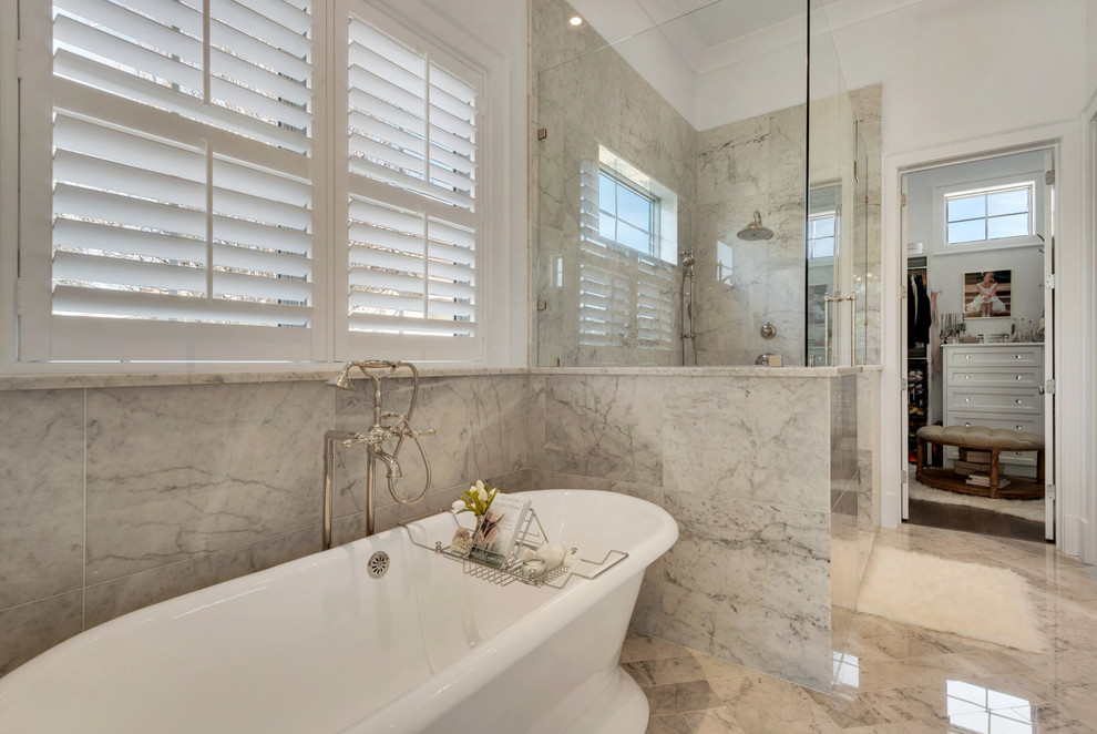 Inspiration for a large beach style master bathroom in Miami with recessed-panel cabinets, white cabinets, a freestanding tub, a double shower, white walls and an undermount sink.