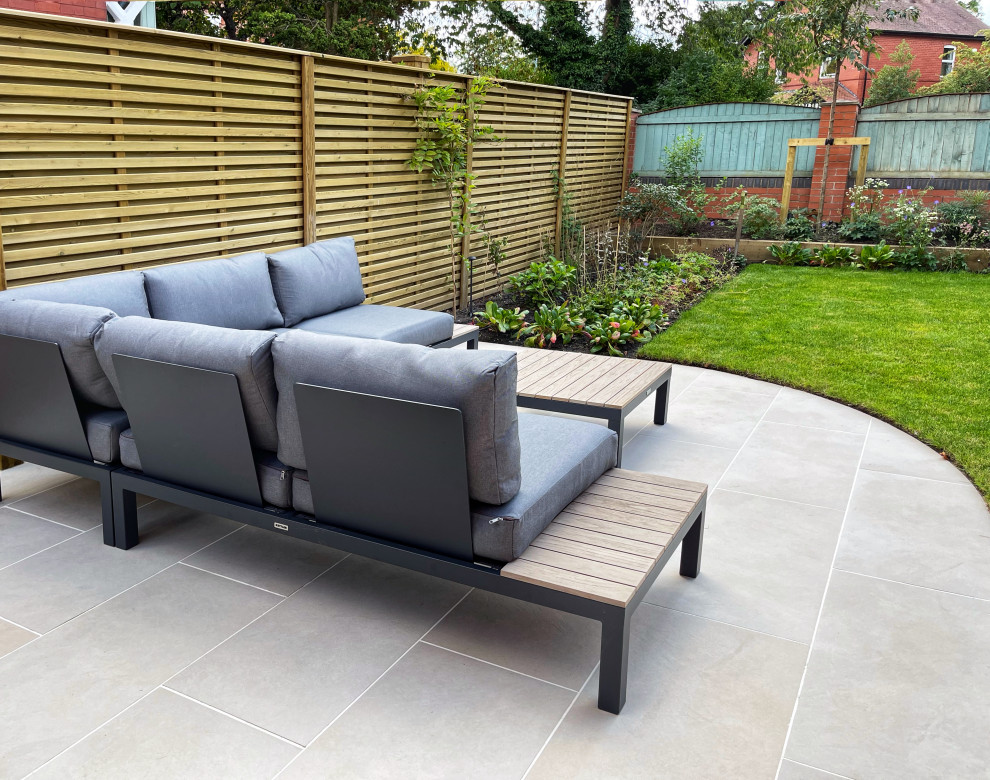 Photo of a medium sized contemporary side full sun garden for summer in Manchester with a wood fence.