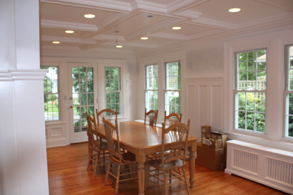 Mid-sized transitional separate dining room in New York with white walls, light hardwood floors and no fireplace.