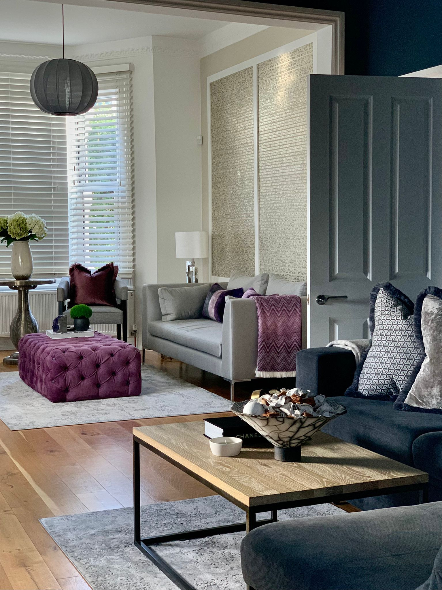 double aspect reception living Tv rooms had a complete transformation with neutral grey base and luxurious purple accents: