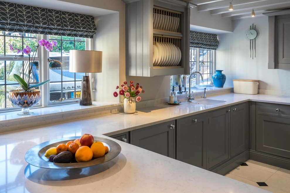 This is an example of a large traditional u-shaped separate kitchen in Kent with shaker cabinets, grey cabinets, quartzite benchtops, stainless steel appliances, no island and white benchtop.