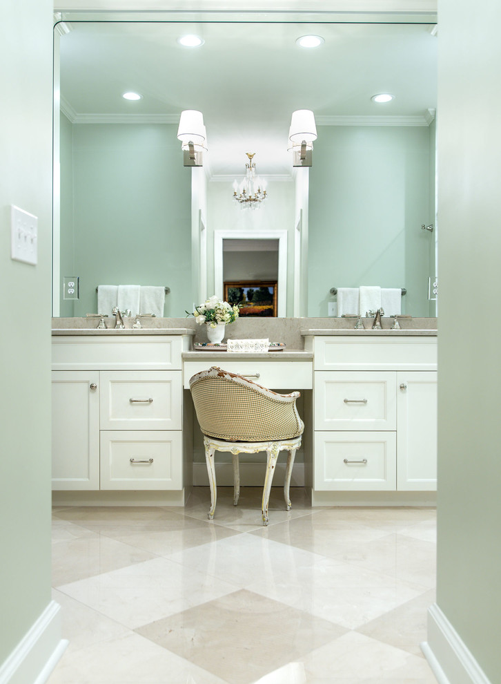 Photo of a mid-sized traditional master bathroom in Nashville with recessed-panel cabinets, white cabinets, a curbless shower, a one-piece toilet, white tile, marble, green walls, marble floors, an undermount sink, engineered quartz benchtops, beige floor, a hinged shower door and beige benchtops.