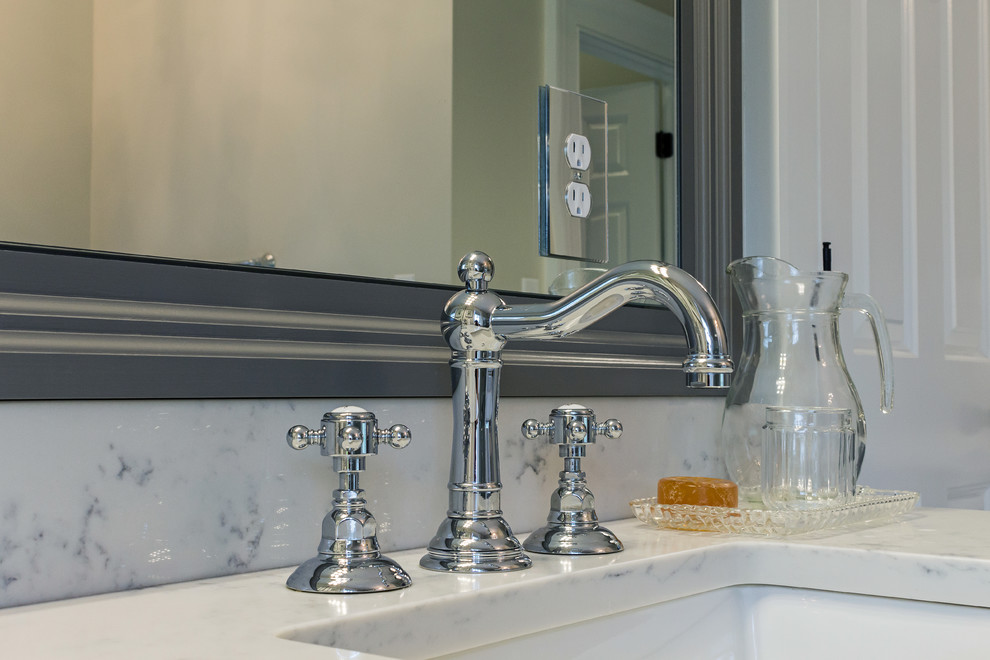 Mid-sized transitional master gray tile and subway tile ceramic tile and white floor corner shower photo with raised-panel cabinets, gray cabinets, an undermount tub, a two-piece toilet, beige walls, an undermount sink, marble countertops and a hinged shower door