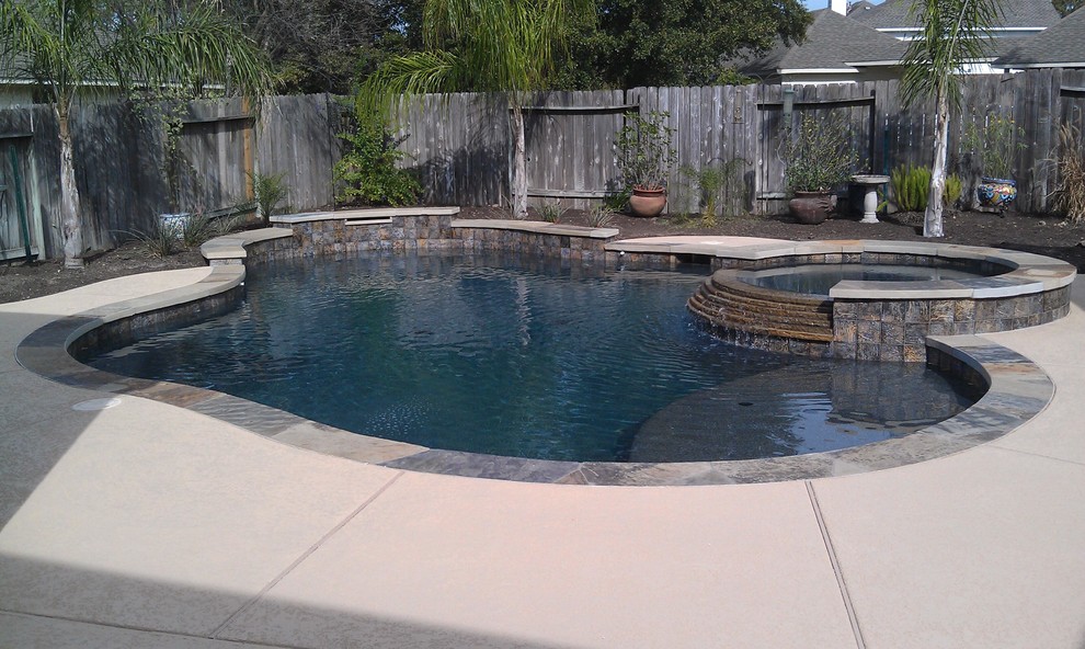 Inspiration for a mid-sized contemporary backyard custom-shaped pool in Houston with a hot tub.