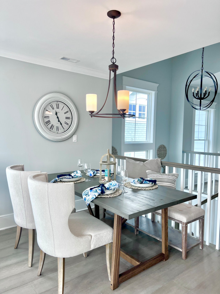 Inspiration for a beach style dining room in Other with grey walls, light hardwood flooring and grey floors.