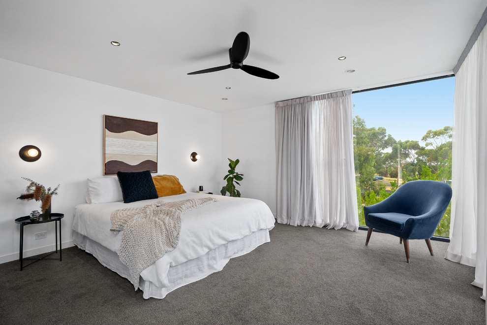 Modern master bedroom in Geelong with white walls, carpet and grey floor.
