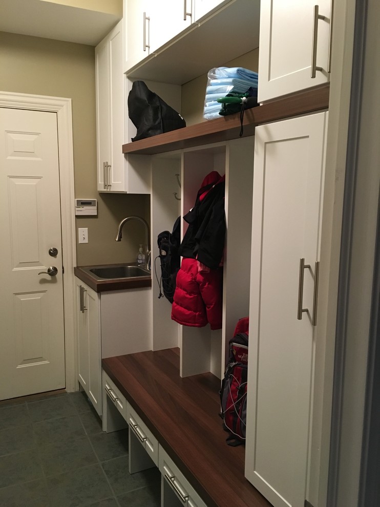 Mid-sized contemporary gender-neutral built-in wardrobe in Chicago with recessed-panel cabinets and white cabinets.