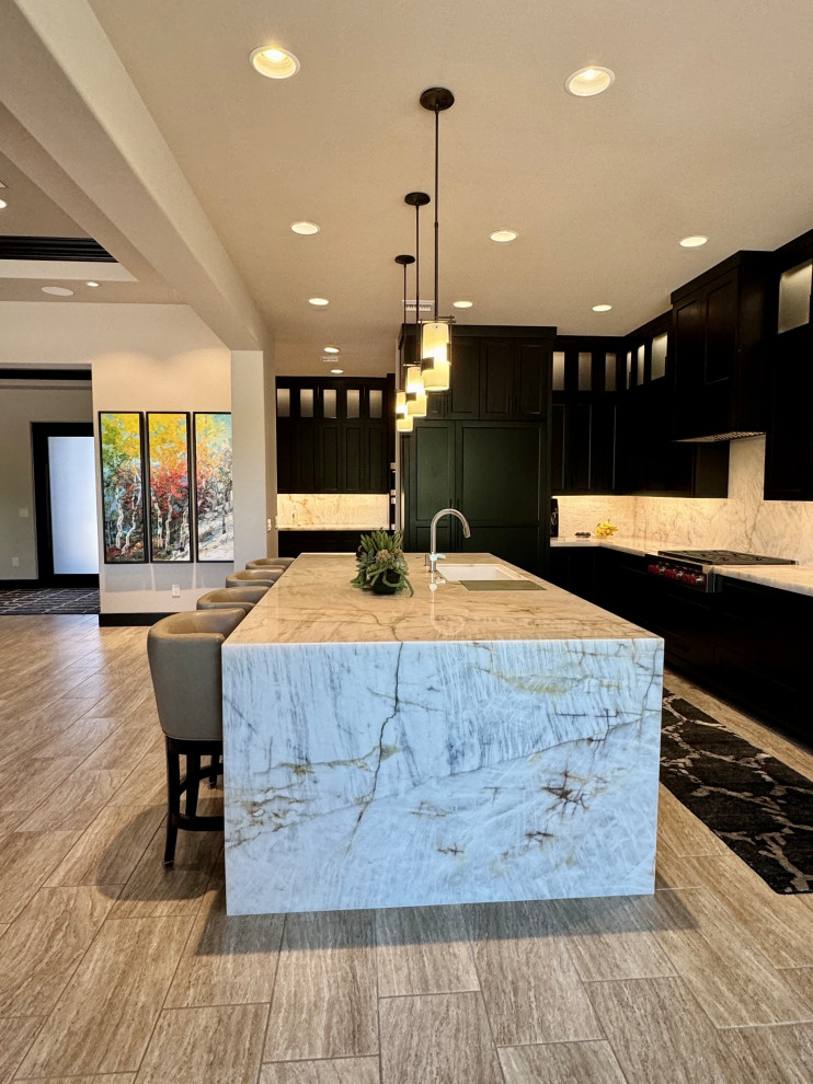 Kitchen pantry - large transitional l-shaped porcelain tile and beige floor kitchen pantry idea in Phoenix with an undermount sink, shaker cabinets, dark wood cabinets, quartzite countertops, beige backsplash, stone slab backsplash, paneled appliances, an island and beige countertops