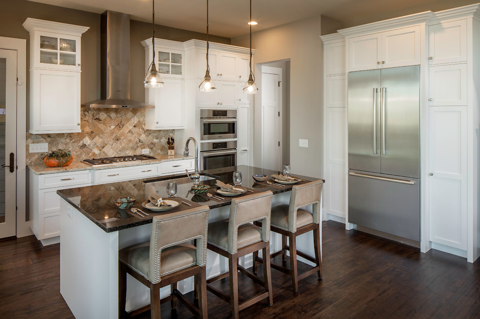 Mid-sized transitional l-shaped dark wood floor and brown floor eat-in kitchen photo in Charlotte with a single-bowl sink, shaker cabinets, white cabinets, granite countertops, beige backsplash, stone tile backsplash, stainless steel appliances, an island and brown countertops