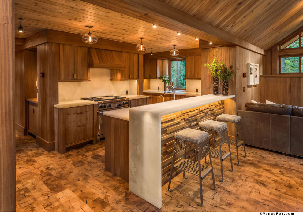 Midcentury l-shaped open plan kitchen in Sacramento with flat-panel cabinets, medium wood cabinets, white splashback, stone slab splashback, panelled appliances and cork floors.