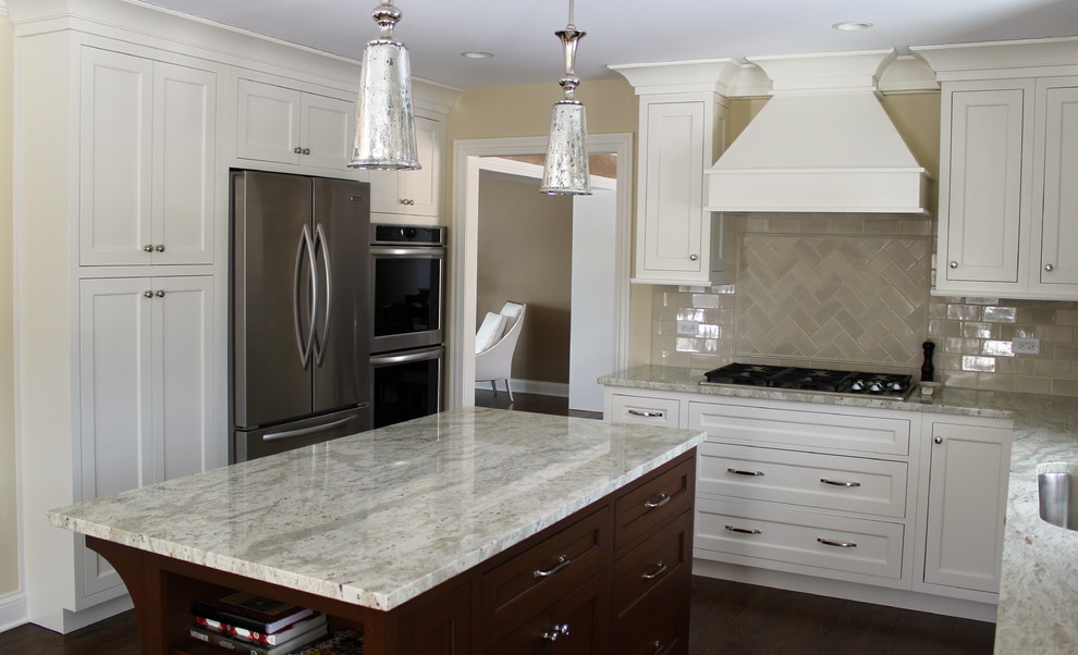Example of a mid-sized transitional u-shaped dark wood floor and brown floor eat-in kitchen design in Chicago with beige cabinets, granite countertops, beige backsplash, ceramic backsplash, stainless steel appliances, beige walls, an undermount sink, recessed-panel cabinets, an island and beige countertops