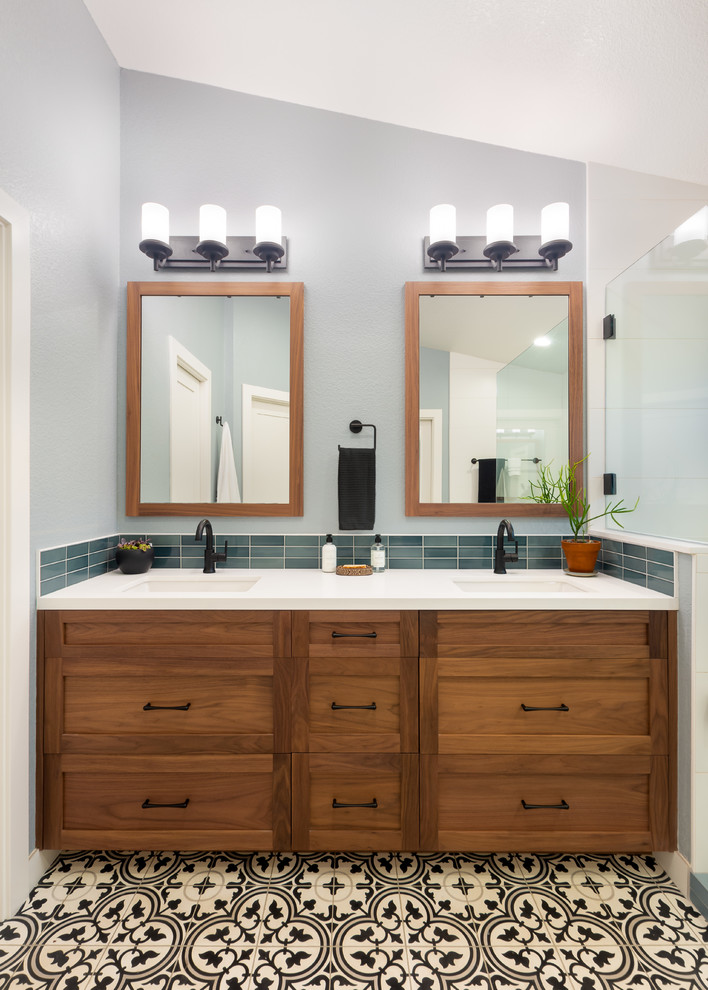 Large transitional bathroom in Sacramento with shaker cabinets, medium wood cabinets, ceramic tile, grey walls, cement tiles, an undermount sink, engineered quartz benchtops, multi-coloured floor, white benchtops and blue tile.