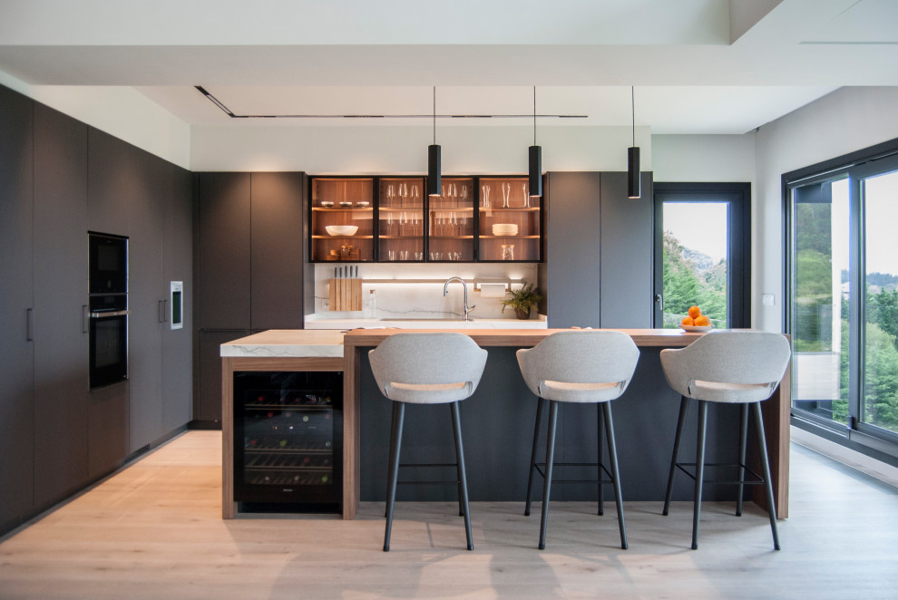 Example of a large trendy l-shaped open concept kitchen design in Bilbao with gray cabinets, marble countertops, an island and white countertops