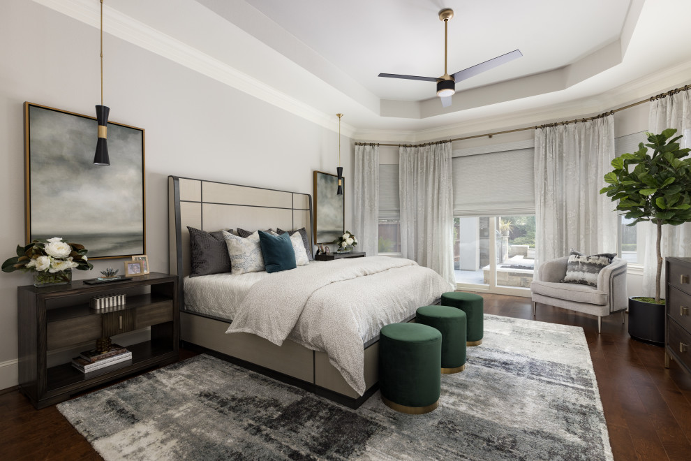 This is an example of a transitional bedroom in Houston with grey walls, medium hardwood floors, brown floor and recessed.
