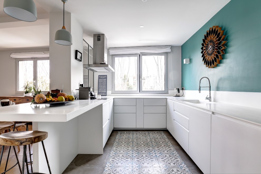 Inspiration for a scandinavian u-shaped kitchen in Tel Aviv with a drop-in sink, flat-panel cabinets, white cabinets, white splashback, panelled appliances, multi-coloured floor and white benchtop.